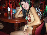 Filipina dancer at Pony Tails club, Angeles City, Philippines, sitting at table with me.